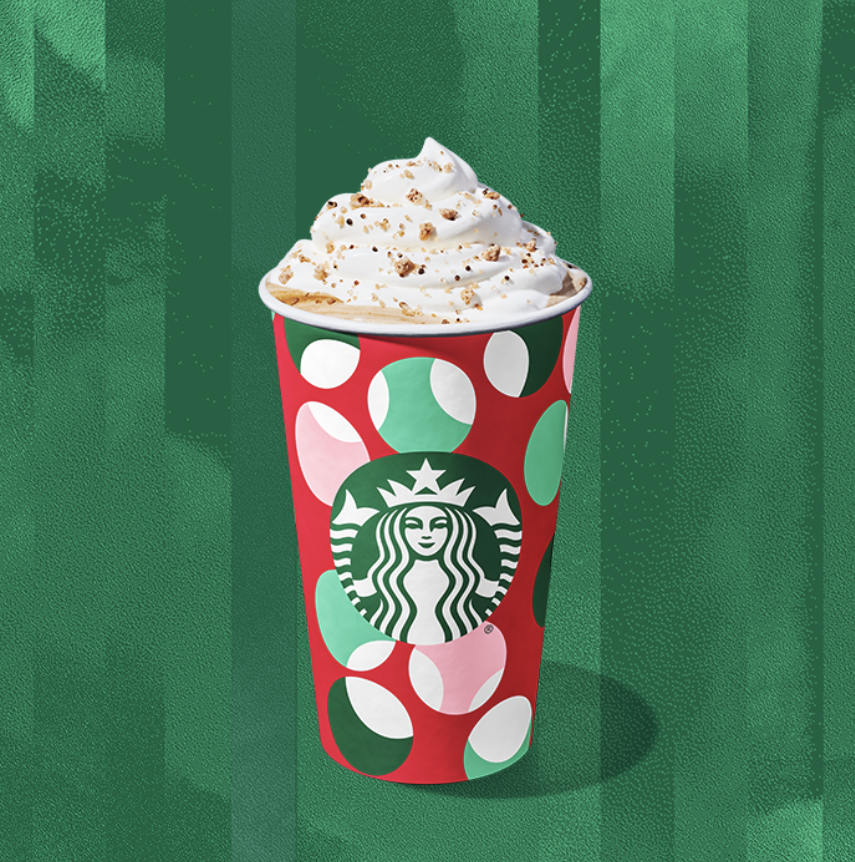 Chestnut Praline Latte comes with whipped cream and a spiced sugar topping.