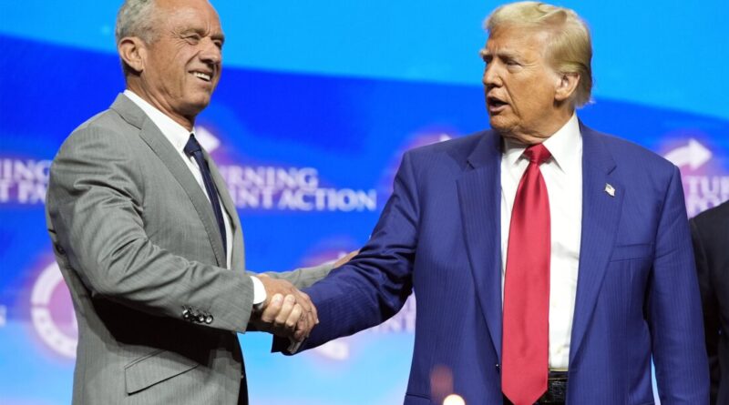 President-elect Donald Trump shakes hands with Robert F. Kennedy Jr., at a campaign rally in October. Kennedy, a vaccine skeptic, is one of Trump's health advisers.