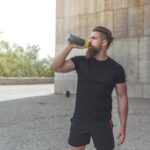 athlete resting after running stock photo